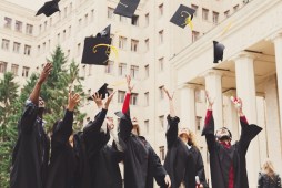 graduates throwing caps