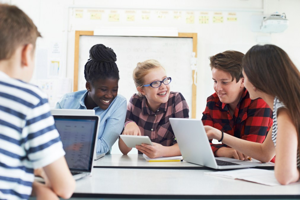 teens using laptops in class