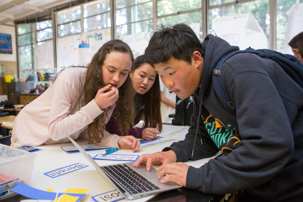 students looking at laptop