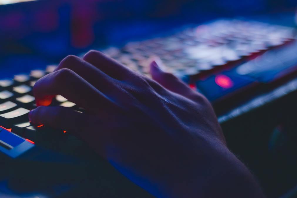 a hand on a computer keyboard