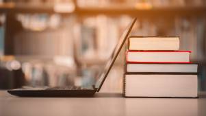 books and a laptop in a library