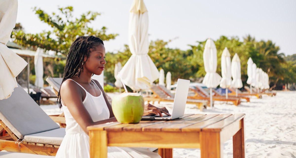 woman studying on the beach