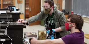 two students film a lab session