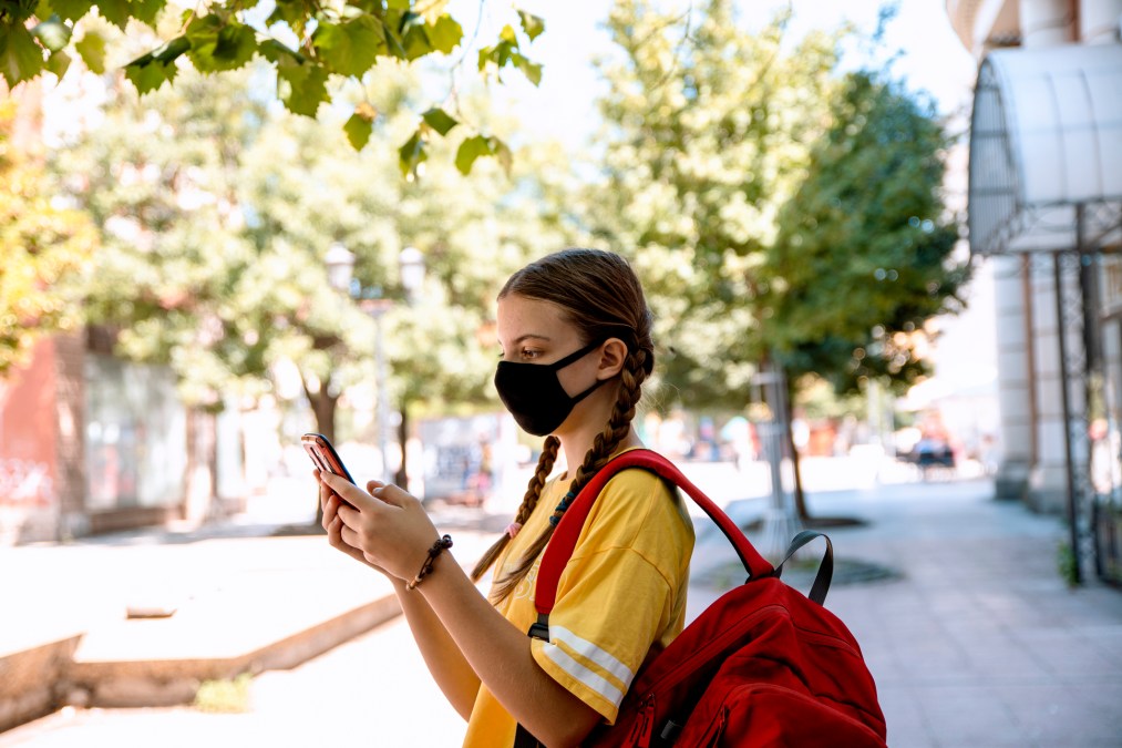 university student checking phone on campus